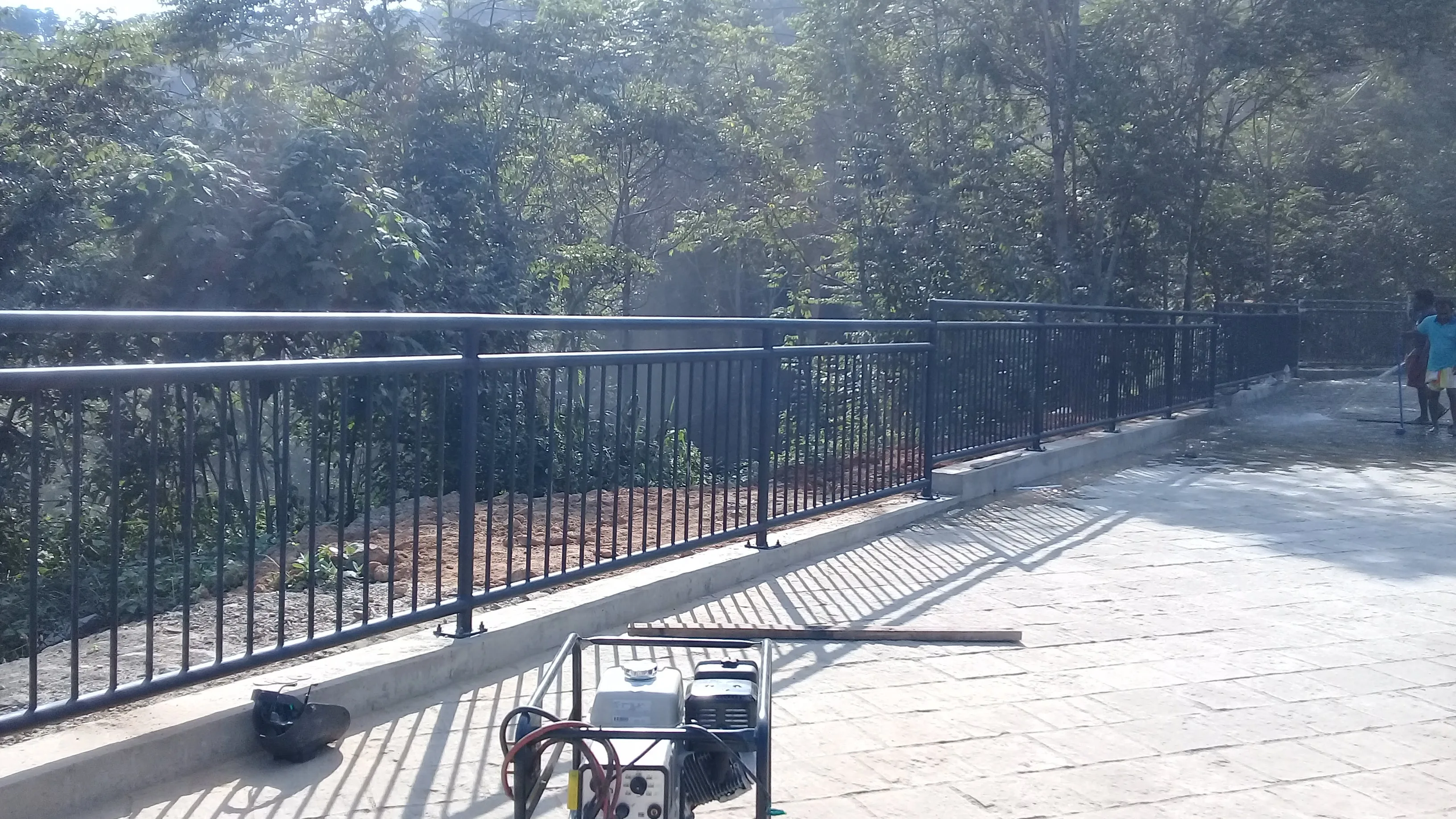 Guard railing installation on expressway with orange safety markers