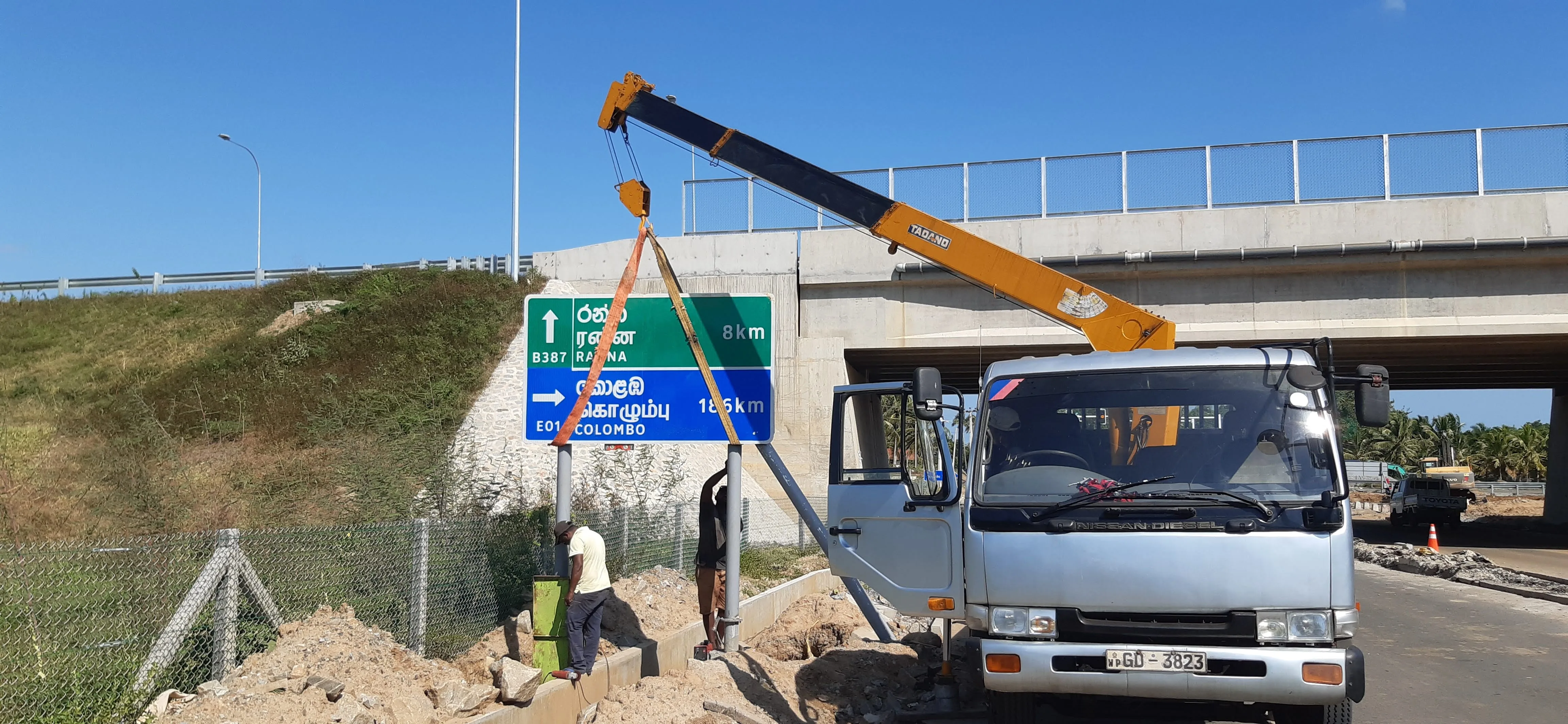 Highway sign board installation with safety railings and signage